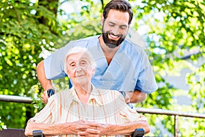 Geriatric nurse giving senior woman massage