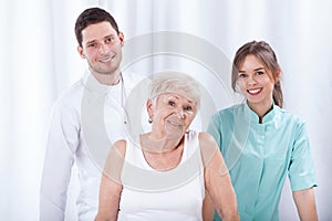 Geriatric patient with her physiotherapists photo
