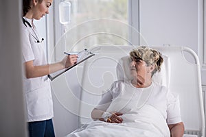 Geriatrician talking with senior woman photo