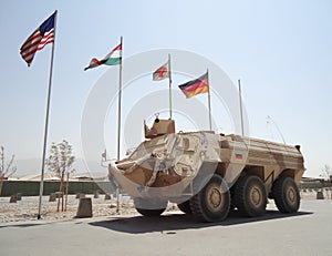German armored ambulance vehicle fuchs in front of national flags