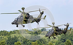 German Army Eurocopter Tiger attack helicopters taking off from a grass strip. Buckeburg, Germany - June 17, 2023 photo