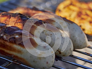 german bratwurst pork sausage cooking on a barbecue grill