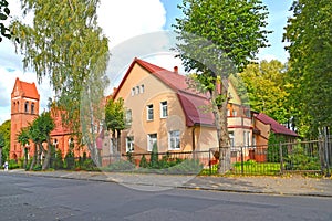 A German-built residential building 1910 and a fragment of the building of the church of the suburb of Ponart. Marshal Novikov S