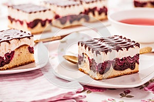 German cake Donauwelle Danube waves - vanilla and chocolate sponge cake with sour cherries, vanilla buttercream and chocolate