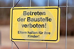 German construction side sign on a fence