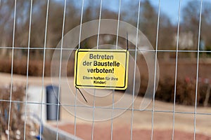 German construction side sign on a fence
