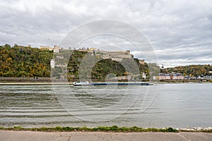 German corner, Koblenz were Rhein and Mosel meet. A river barge in the foreground with the fortress Ehrenbreitstein in