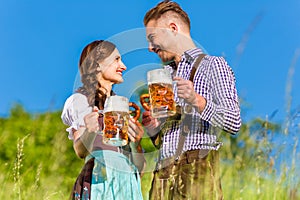 German couple in Tracht with beer, pretzel