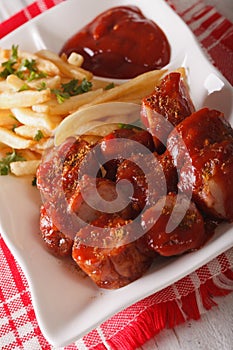 German cuisine: currywurst with french fries close-up. vertical