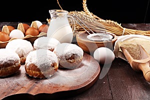 German donuts or berliner with ingredient on rustic background