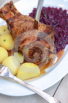German Eisbein with braised cabbage(Sauerkraut),salad and beer,roasted pork knuckle.call Schweinshaxe,Haxe,Bavarian photo