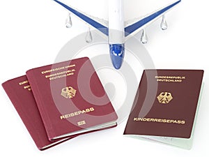 German family passports with plane isolated white background