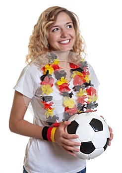 German female soccer fan with ball looking sideways