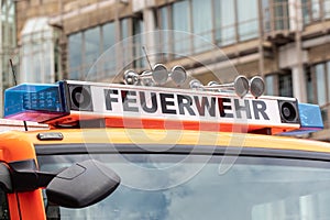 German Fire Truck with Feuerwehr Sign and Emergency Lights: First Responder and Public Safety Equipment