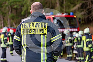 German firemen stands near a fire truck during an exercise