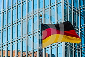 German flag on the background of office building, Atlanta, USA