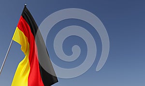 German flag on flagpole on blue background. Place for text. The flag is unfurling in wind. German, Berlin. Europe. 3D illustration