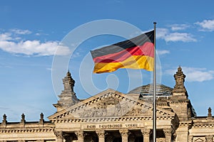 German Flag in front of the German Parliament Bundestag - Reichstag Building - Berlin, Germany