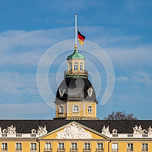 German Flag at Halfmast, auf Halbmast, on the top of Castle Karlsruhe at winter. In Karlsruhe, Baden-WÃ¼rttemberg, Germany