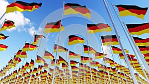 German Flags on flagpoles against blue sky