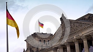 German flags outside the Reichstag or Deutscher Bundestag German Parliament building in Berlin, Germany