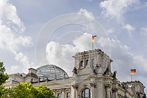 German flags waving on the ancient buildings of the historic center of Berlin, Germany, against a dramatic sky