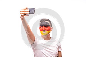 German football fan take selfie photo with phone on white background.