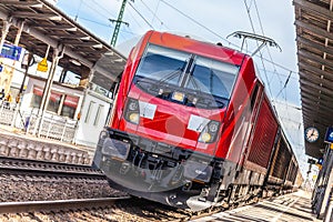 Freight train passes a train station