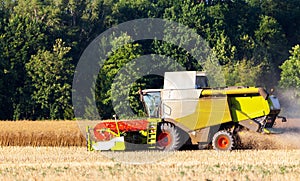German havester works on a corn field