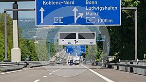 German highway with visible cars, signs and exits. Motorway without speed limit.