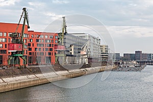 German inner harbour with port cranes in Duisburg
