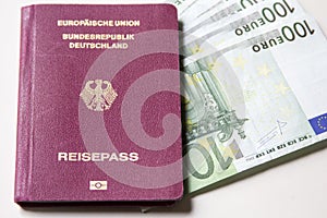 German international traveling passport and euro money.