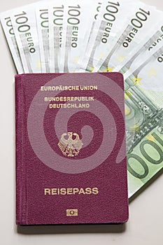 German international traveling passport and euro money.