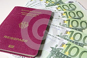 German international traveling passport and euro money.