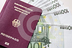 German international traveling passport and euro money.