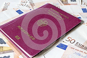 German international traveling passport and euro money.