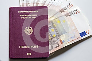 German international traveling passport and euro money.