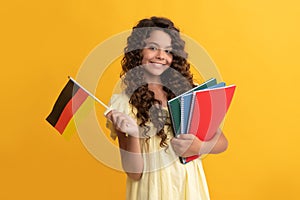 german language. child hold flag. back to school. teen girl study in germany. happy childhood.