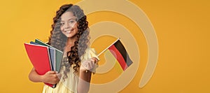 german language. child hold flag. back to school. teen girl study in germany. Portrait of schoolgirl student, studio