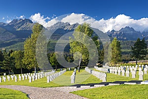 German military cemetery in autumn with mountains in the background and many graves of soldiers killed in the Second World War.