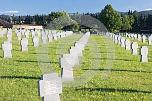 German military cemetery in autumn with mountains in the background and many graves of soldiers killed in the Second World War.