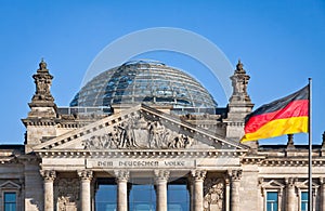 German National flag waving in front of German parliament building in Berlin