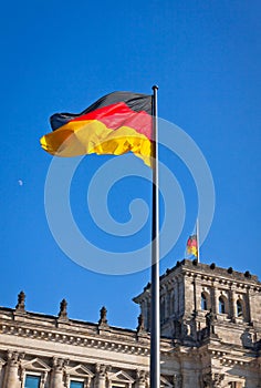 German National flag waving in front of German parliament building in Berlin