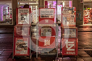 German newspaper Bild Zeitung for sale in the streets of Munich on stands, surrounded by TV Journal and ZT