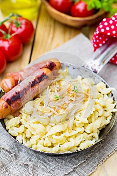 German noodles Spatzle with fried onions and sausages
