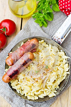 German noodles Spatzle with fried onions and sausages