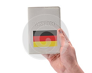 German passport in a man`s hand on white background