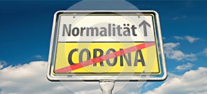 German place-name sign with the words `Corona` and the Geman word `NormalitÃ¤t`