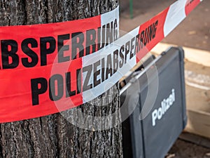 German Police barrier tape with suitcase