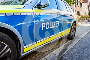 German police car on a street. Side view of a police car with the lettering Polizei. Police patrol car parked